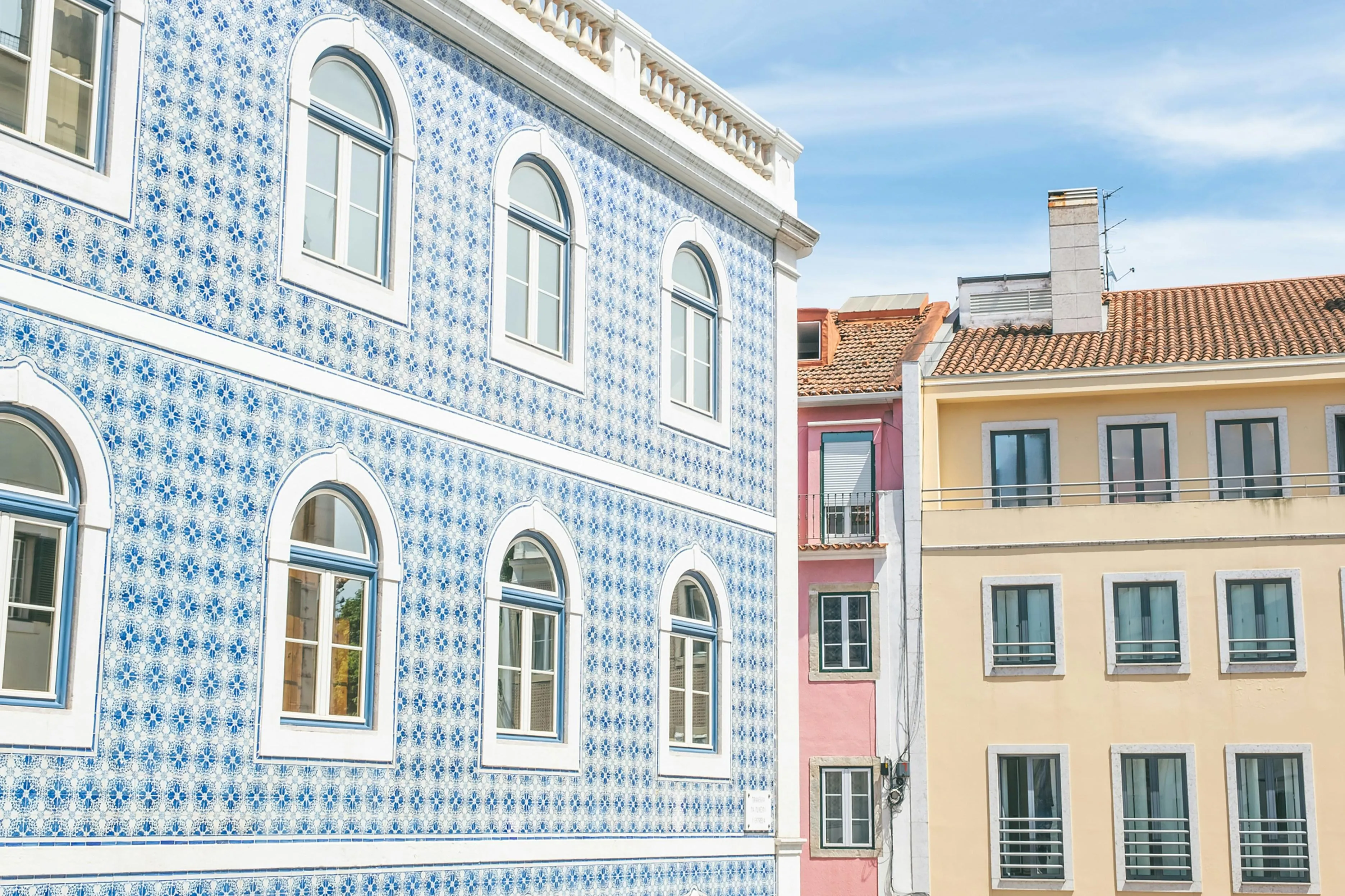 A maintained Portuguese apartment building showing signs of everyday residential life